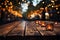 Bokeh lights paint ethereal backdrop, wooden table rests in tranquil outdoor cafe