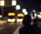 Bokeh of night street lights. People and vehicles on a blurred background. Generative AI