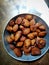 Bokeh shot of delicious indian dessert made of sugar , jaggery , dry fruits and flour called Gulgula.