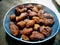 Bokeh shot of delicious indian dessert made of sugar , jaggery , dry fruits and flour called Gulgula.