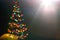 Bokeh silhouette of Christmas tree.blur light celebration on christmas tree on dark wall background. Abstract Christmas tree