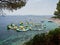 Bol, Croatia, July 25, 2021: Zlatni Rat beach full of tourists and inflatable water park. Symbol of the Adriatic Sea on the island