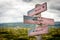 Bold bright and brave text on wooden american flag signpost outdoors