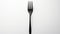 Bold Chromaticity A Black Fork On A White Background