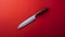 Bold Chromaticity: Wooden Knife On Red Background