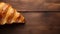 Bold And Innovative Croissant: A Texture-rich Delight On Wood Table