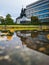 Boleslaw Chrobry statue in front of Renoma mall reflected in puddle