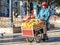 BOLIVIA, POTOSI, 4 JULY 2008: Street orange juice seller with small carriage in Potosi, Bolivia, South America