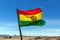 Bolivian Flag waving in the wind against blue sky background