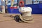 Bollard with robe attached to it to secure anchored boat in Oudeschild harbor on island Texel in Netherlands