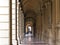 BOLOGNA, ITALY - 17 FEBRUARY, 2016: People Walking through a Portico, sheltered walkway, in Bologna with its almost 40 kilometres.