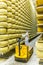 BOLOGNA , ITALY - MAY 02, 2018: Worker inspecting cheese in Parmigiano Cheese factory. Shelves with aging cheese in Italy, Bologna