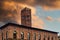 Bologna, Italy13th-century Palazzo Podesta with tower against dramatic orange clouds