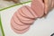 Bologna sausage thin sliced cut with knife