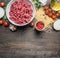 Bolognese pasta cooking concept, raw minced meat, tomato paste, cherry tomatoes, pasta, onion, garlic, herbs herbs, oil and ho