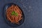 Bolognese vegan Bucatini, meatless, with soy sauce, tomatoes, sesame seeds and fresh basil.
