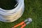 Bolt cutter near the coil wire on the grass. Tool, technology