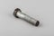 Bolt fastening of the tie spring on a gray background. Truck spare parts mounting bolt. Transmission mounting bolt