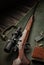 Bolt small caliber rifle 22lr with an optical sight on a wooden background. Hunting small-caliber weapon on a wooden table