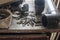 bolts and screws and all sorts of old junk on a dusty wooden table in the garage