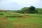 Bomb craters from the Vietnam War surround giant megalithic stone urns at the Plain of Jars archaeological site in Loas.