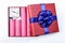 Bomb sticks of dynamite, in a gift box with a blue ribbon with c