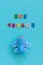 Bon voyage colorful text and children`s funny toy plane on blue paper background. Top view Concept travel, tourism. Template for