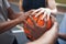 Bonded by basketball. Closeup shot of a group of sporty young men huddled around a basketball on a sports court.