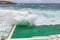 Bondi beach swimming pool in Sydney, Australia travel. Ocean waves crashing on famous popular tourist attraction on the