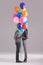 Bonding behind balloons. Studio shot of a couple hiding behind a bunch of balloons.