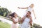 Bonding, Family of three walking on grassy field girl sitting on