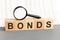 bonds word made with building blocks on white background