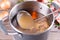 Bone Broth Bouillon in Metal saucepan on the table, paleo diet