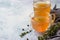 Bone or vegetable broth, bouillon in a glass mug and aromatic herbs on blue stone background. Paleo diet