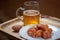 Boneless hot wings on plate with glass mug of beer and football