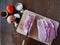 Boneless, slightly frozen pork meat is being sliced on a kitchen board