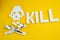 The bones skull made of sugar cubes and dessert spoons on a yellow background. Sugar kills and diabetes concept . The