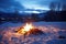 a bonfire surrounded by untouched winter snow