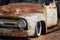 The bonnet of a rusty old Ford F100 series pickup truck with added texture layer, that has been lovingly restored