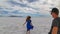 Bonneville - Rear view of couple holding hands standing on Bonneville Salt Flats in Wendover, Western Utah, USA