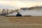 BONNYVILLE, ALBERTA, CANADA - SEPTEMBER 10, 2020: A local farmer in John Deere tractor works infront of a cloud of dust