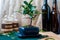 Bonsai ficus panda in a blue pot on a wooden table in the interior