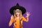 Boo. Photo of little witch lady play enchantress role halloween party holding paper stick scary look wear orange t-shirt