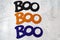 Boo word for Halloween three times, centered, on marble