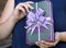 The book as a gift holds women`s hands beautiful design with a bow