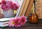 Book with beautiful chrysanthemum flowers as bookmark on wooden table, closeup