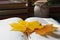 Book with beautiful leaves as bookmark on table, closeup