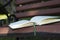 Book on a bench in the evening in the park. There is a diary on a wooden bench