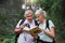 Book, bird watching and reading with old couple in nature for bonding, discovery or travel adventure. Search, hiking and