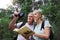 Book, bird watching and search with old couple in nature for bonding, discovery and travel adventure. Relax, hiking and